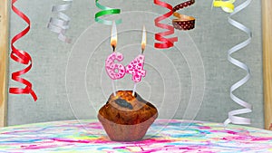 Happy birthday background with muffin with beautiful decorations with number candles 64. Colorful festive card happy birthday