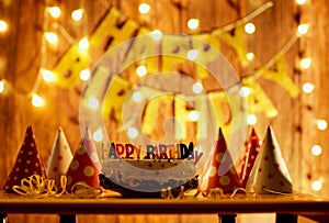 Happy birthday cake with candles on the background of garlands a