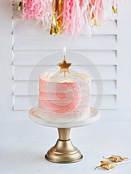 Happy birthday cake shot on a white light background with golden stars candles and space for text. Romantic Celebration Party