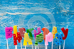 Happy birthday candles on blue background