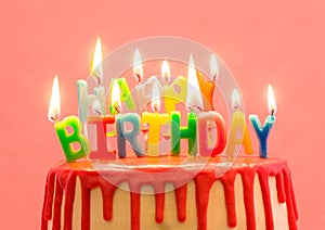 Happy birthday candles. Cake with red chocolate decoration on pink background. Bright candles. Happy birthday. Sweet and