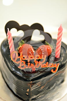 Happy Birthday candles on chocolate cake