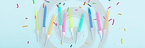 Happy birthday candles and confetti on blue background, top view. Flat lay style. Mockup, template. Horizontal banner for web