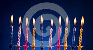 Happy birthday candles over blue photo