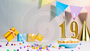Happy birthday card from candles with the number 19, golden numbers from candles for congratulations on any holiday with beautifu
