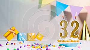 Happy birthday card from candles with the number 32, golden numbers from candles for congratulations on any holiday with beautiful