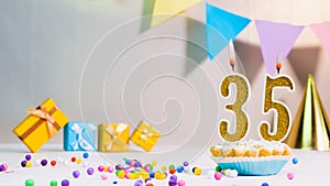 Happy birthday card from candles with the number 35, golden numbers from candles for congratulations on any holiday with beautiful