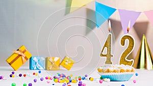 Happy birthday card from candles with the number 42, golden numbers from candles for congratulations on any holiday with beautiful