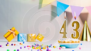Happy birthday card from candles with the number 43, golden numbers from candles for congratulations on any holiday with beautiful
