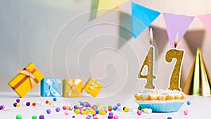 Happy birthday card from candles with the number 47, golden numbers from candles for congratulations on any holiday with beautiful