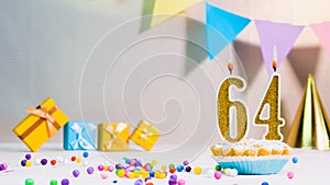 Happy birthday card from candles with the number 64, golden numbers from candles for congratulations on any holiday with beautiful