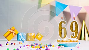 Happy birthday card from candles with the number 69, golden numbers from candles for congratulations on any holiday with beautiful