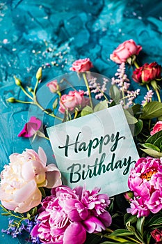 Happy birthday card with flowers on a blue background