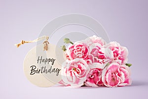 Happy birthday card with pink flowers on purple background