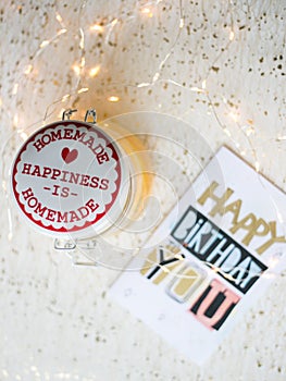 Happy birthday card on a table and Christmas lights