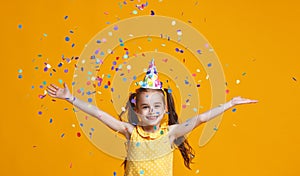 Happy birthday child girl with confetti on yellow background