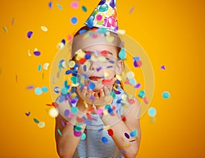 Happy birthday child girl with confetti on yellow background