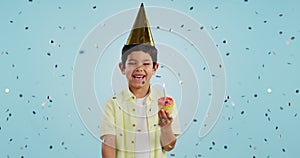 Happy birthday, child and portrait with confetti in party with cupcake, hat and happiness in studio blue background