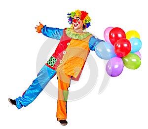 Happy birthday clown holding a bunch of balloons.