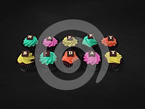 Happy Birthday cupcakes on chalkboard background