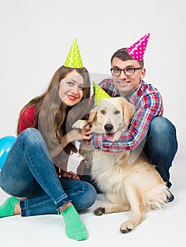 Happy birthday dog with family in birthday hats