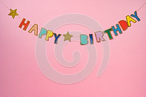 Happy birthday garland on pink background, copy space