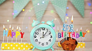 Happy birthday greeting card with muffin pie and retro clock on clock hands new birth. Beautiful background with decorations