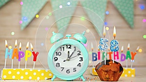 Happy birthday greeting card with muffin pie and retro clock on clock hands new birth. Beautiful background with decorations