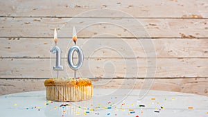 Happy birthday greetings for 10 years from silver numbers on the background of white boards copy space. Beautiful birthday card