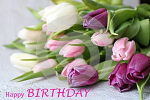 Happy birthday inscription and bunch of tulip, bouquet of flowers for greeting card