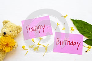 Happy birthday message card handwriting with yellow flowers cosmos ,teddy bear