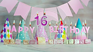 Happy birthday number 16 in pink pastel colors for a girl or woman. Happy birthday greeting card.