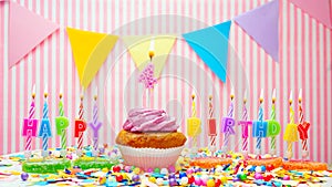 Happy birthday number 4. On a pink background, a happy birthday greeting for a four year old child. Muffins with pink cream