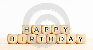 Happy Birthday phrase in wooden blocks on table