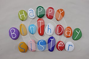 Happy Birthday Sister with colored stones over white sand