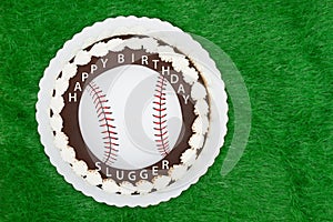 Happy Birthday Slugger baseball cake on a green fake grass photo