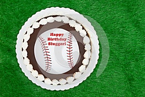 Happy Birthday Slugger baseball cake on a green fake grass photo