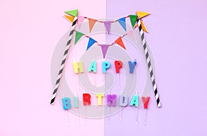 Happy Birthday text with colorful paper flags garland.