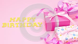 Happy birthday title appear on pink theme with gifts. Stop motion