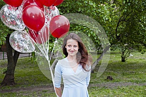 Happy birthday to me! happy woman with party birthday baloons outdoor in summer.