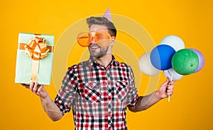 happy birthday to you. male holiday celebration. bearded guy with party balloons and gift box. unshaven handsome man