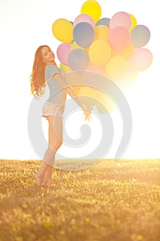Happy birthday woman against the sky with rainbow-colored air ba