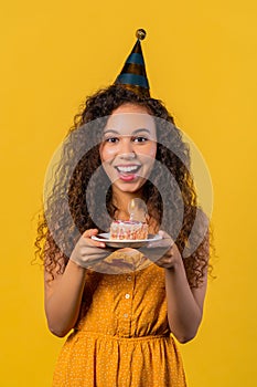 Happy birthday woman making wish - candle on cake. Girl smiling, celebrating.