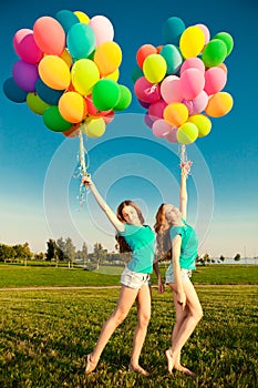 Happy birthday women against the sky with rainbow-colored air ba