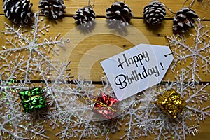 Happy Birthday write on label with wooden backgroud. Frame of Christmas Decoration