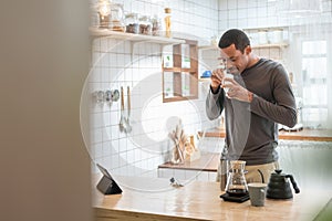 Happy Black African American male making coffee