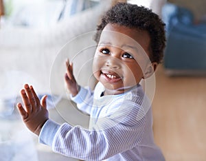 Happy black baby boy, childhood development and child with smile standing against window at family home. Happiness with