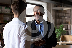 Happy black ceo handshaking rewarding successful worker, employe photo