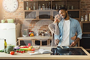 Happy black couple cooking healthy food together