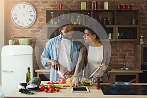 Happy black couple cooking healthy food together